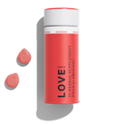 1906 Love herbal supplement pills for arousal in a red container with two pink pills beside it.