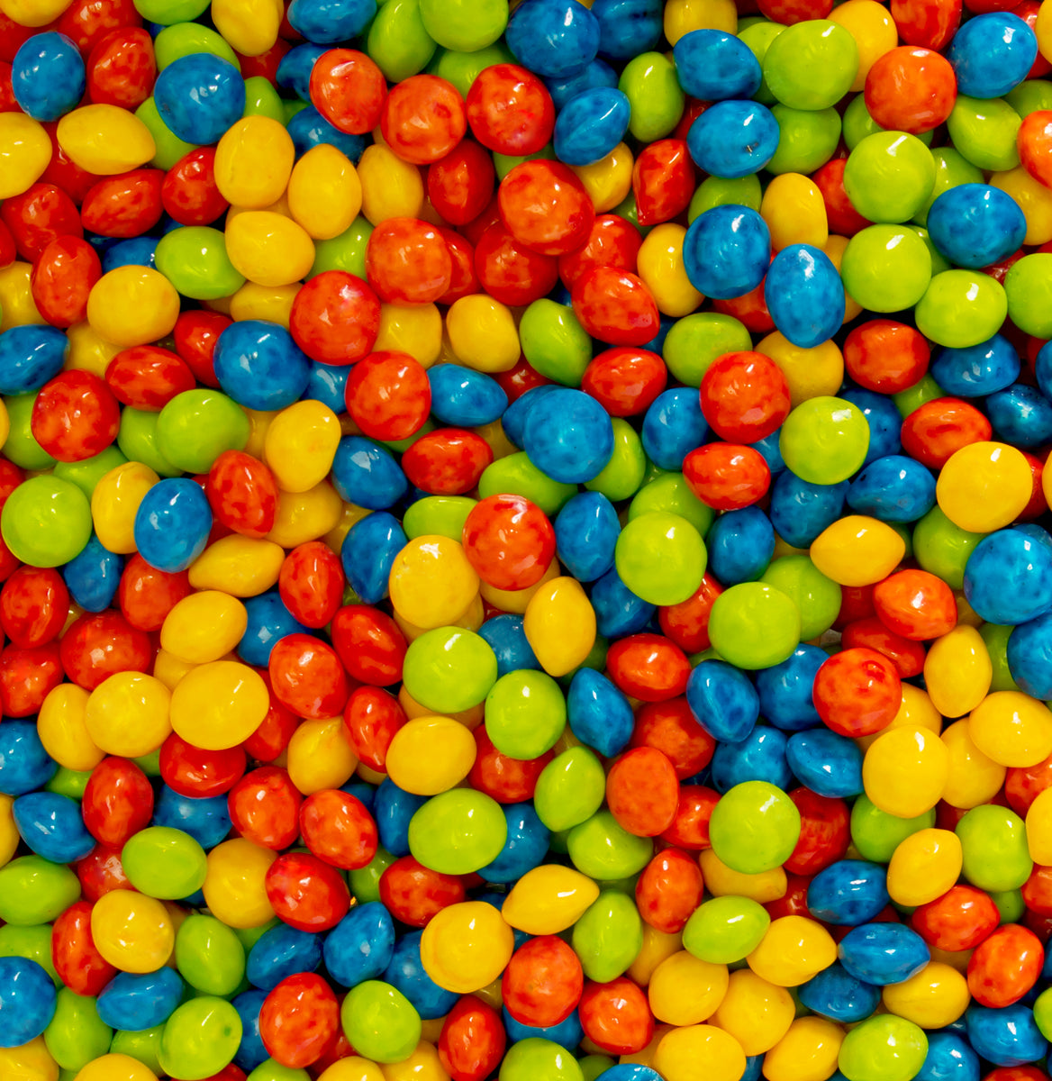 Colorful assortment of Joy Bombs Sour Fruit hemp chews, featuring vibrant red, blue, green, and yellow candies.