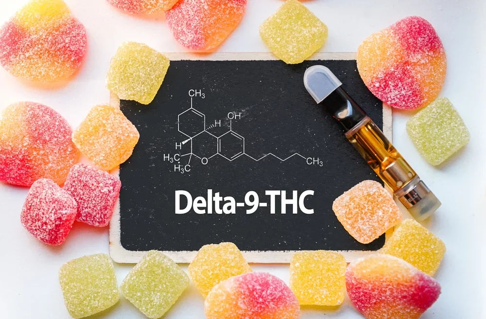 Hemp delta-9 THC gummies and a vape cartridge surrounding a sign labeled Delta-9-THC, connecting the question: is delta-9 legal?