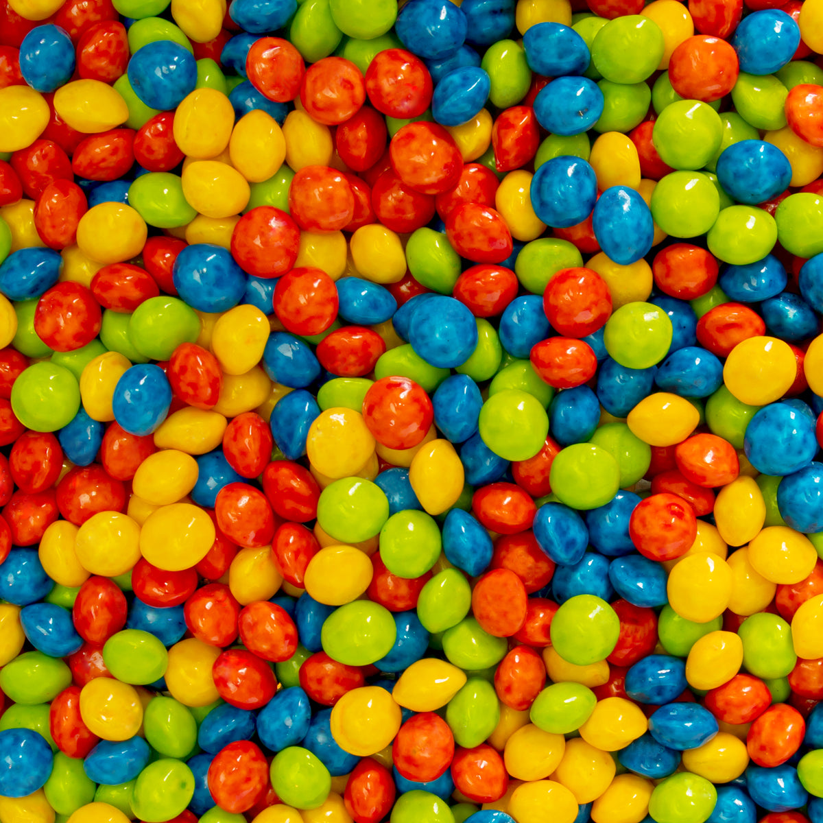 Colorful assortment of Joy Bombs Sour Fruit hemp chews, featuring vibrant red, blue, yellow, and green candies.